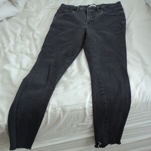 Good American Black Skinny Jeans with Distressed Hem